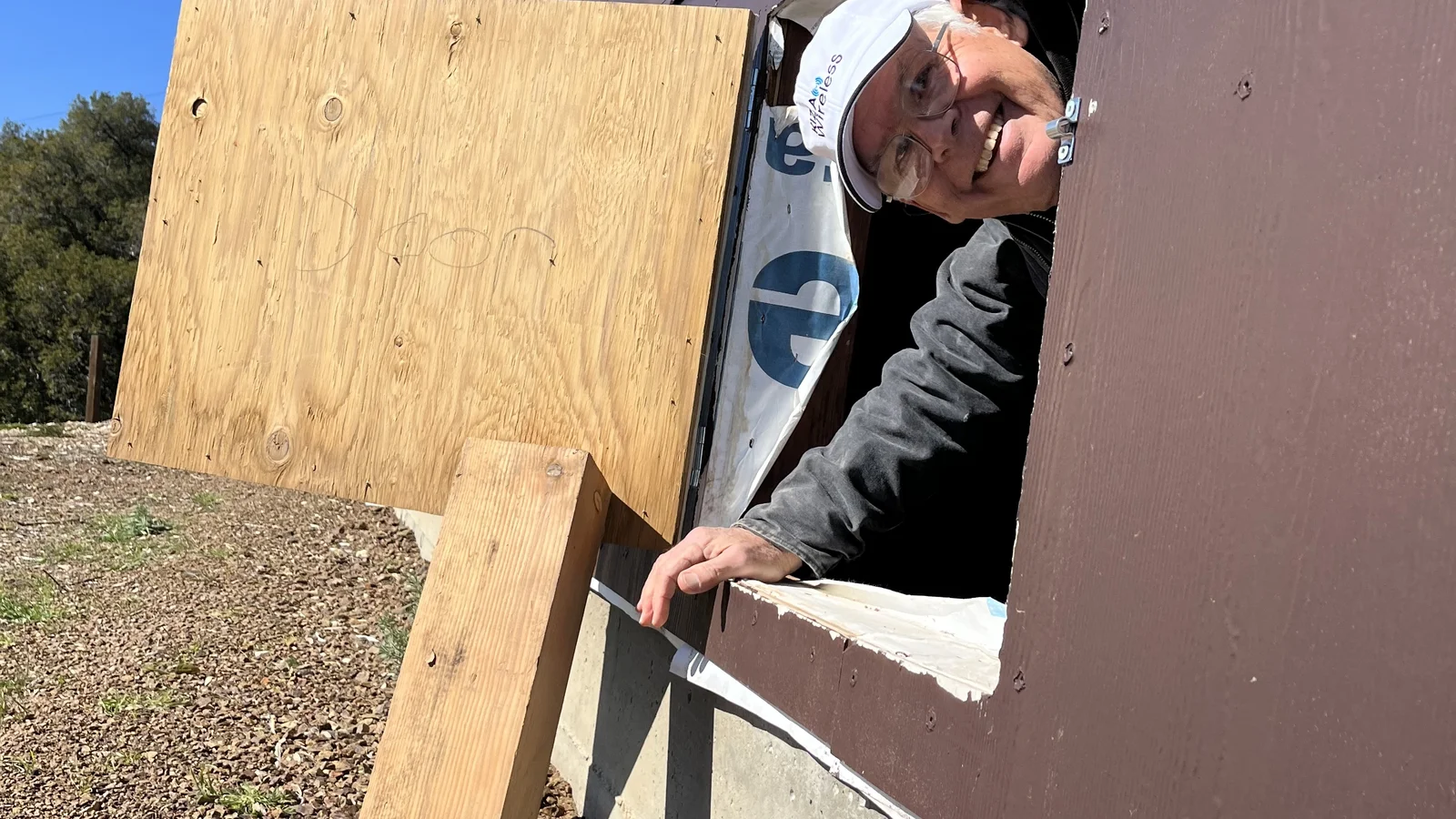 KIZA technician emerging from crawlspace access hole