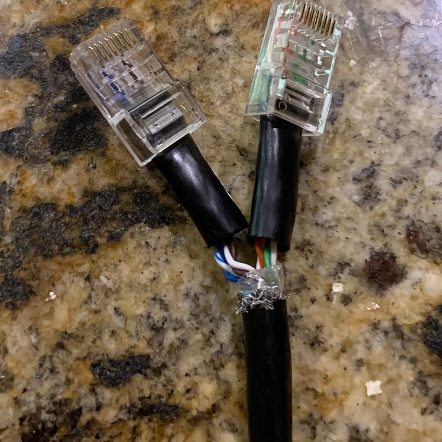 Spliced Ethernet cable with wire nuts joining exposed pairs