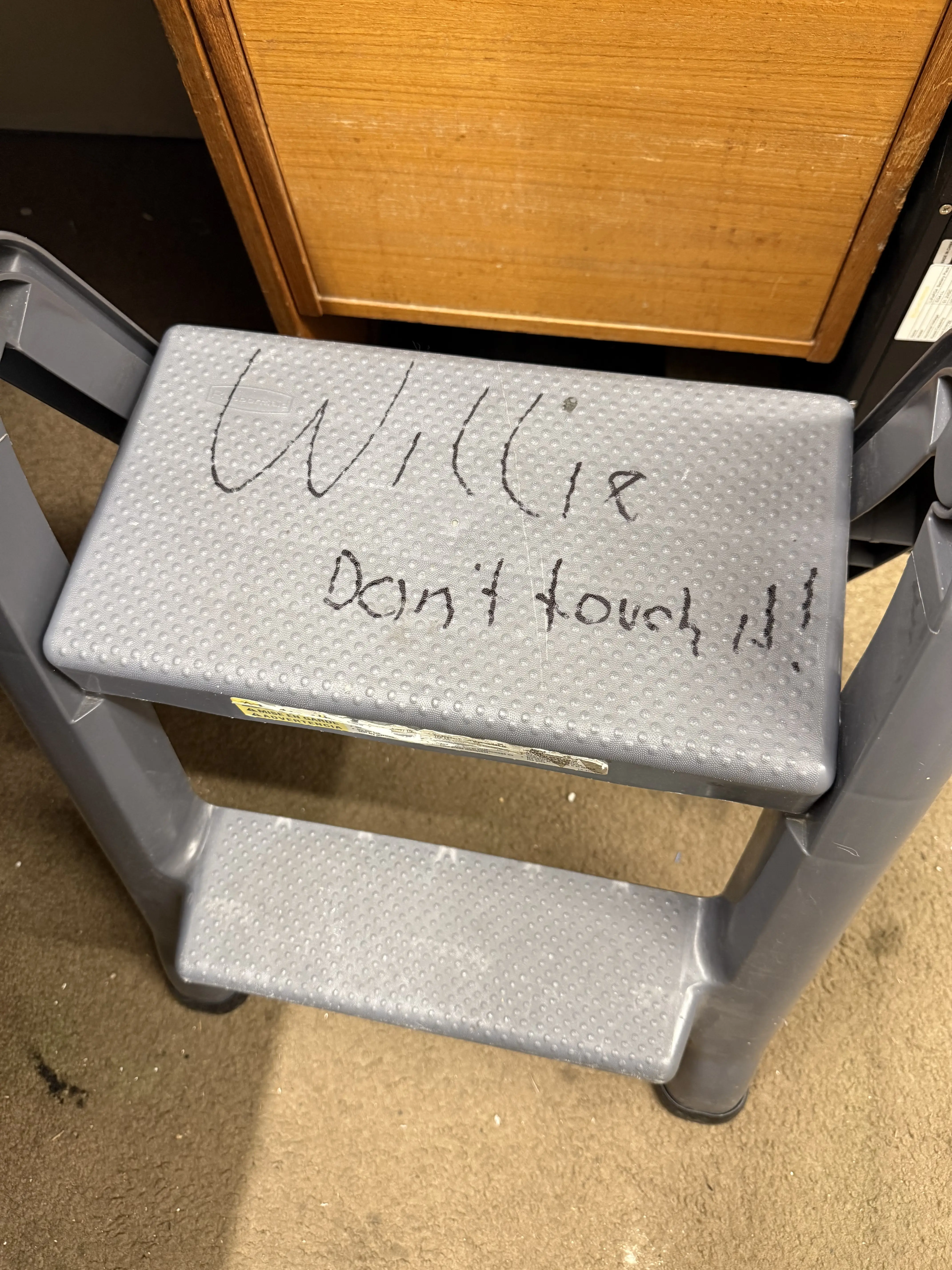 Step stool with 'Willie Don't touch it!!' written in marker on the top